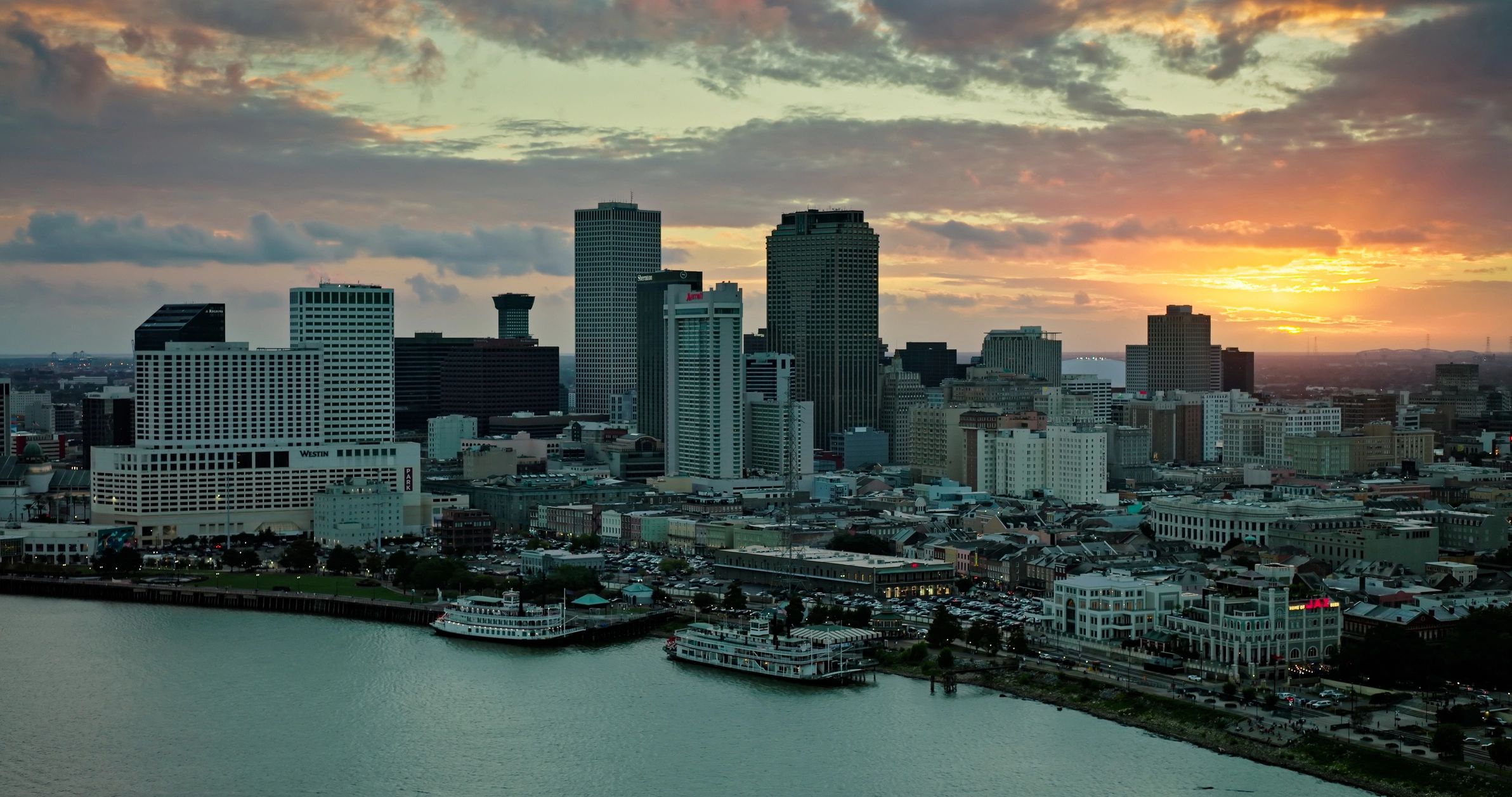 Downtown skyline at sunset representing real estate market coverage